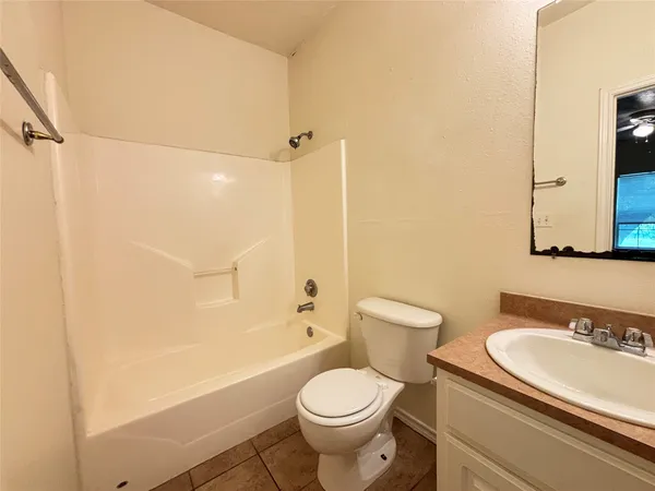a bathroom with a granite countertop toilet sink and shower