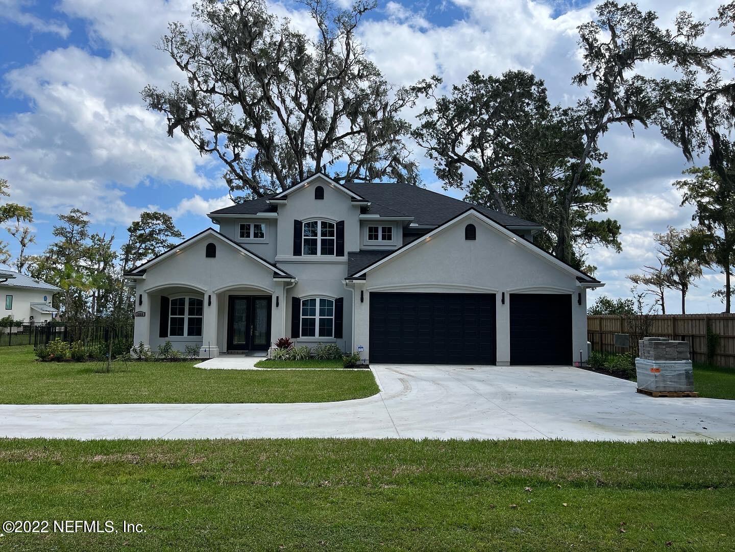1559 Community Point Fleming Island, FL 32003 - Photo 2 of 3 a front view of a house with a garden and trees