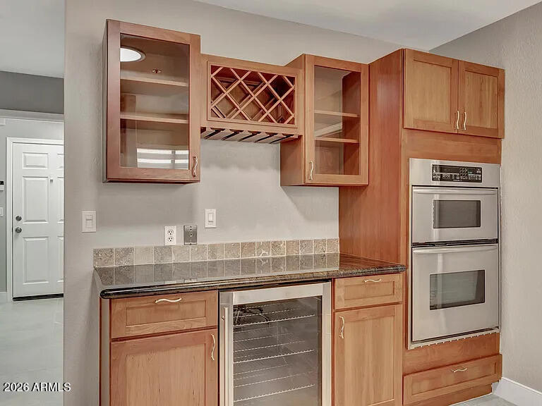 7773 East Stallion Road Scottsdale, AZ 85258 - Photo 11 of 33 a kitchen with stainless steel appliances granite countertop a cabinets and a stove top oven
