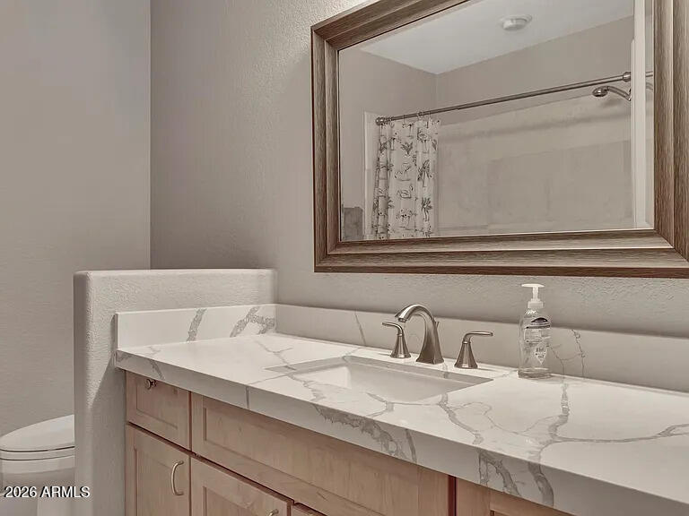 7773 East Stallion Road Scottsdale, AZ 85258 - Photo 18 of 33 a bathroom with a sink and mirror