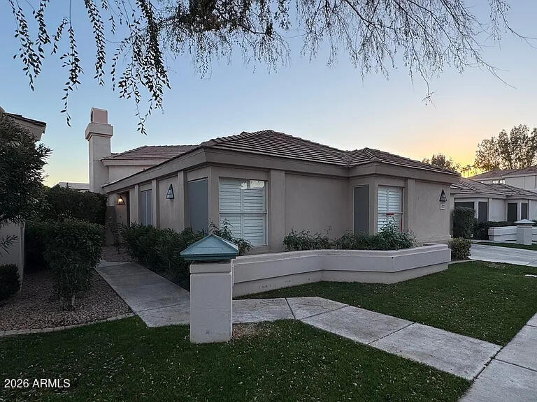 7773 East Stallion Road Scottsdale, AZ 85258 - Photo 2 of 33 a front view of a house with a garden and yard