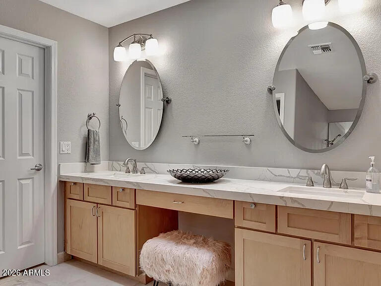 7773 East Stallion Road Scottsdale, AZ 85258 - Photo 22 of 33 a bathroom with a double vanity sink and a mirror