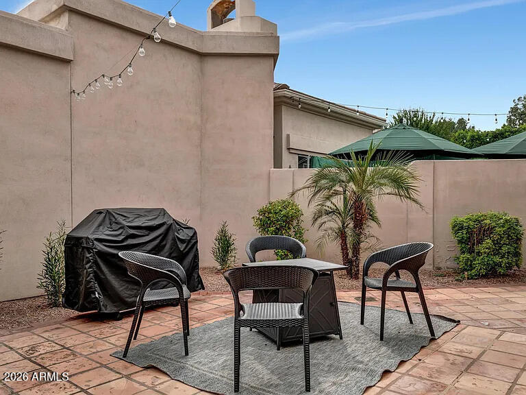 7773 East Stallion Road Scottsdale, AZ 85258 - Photo 27 of 33 a patio with a table and chairs and potted plants