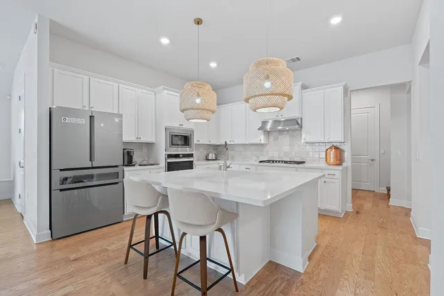 a kitchen with a sink stainless steel appliances and cabinets