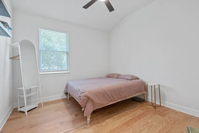 a bedroom with a bed and a window