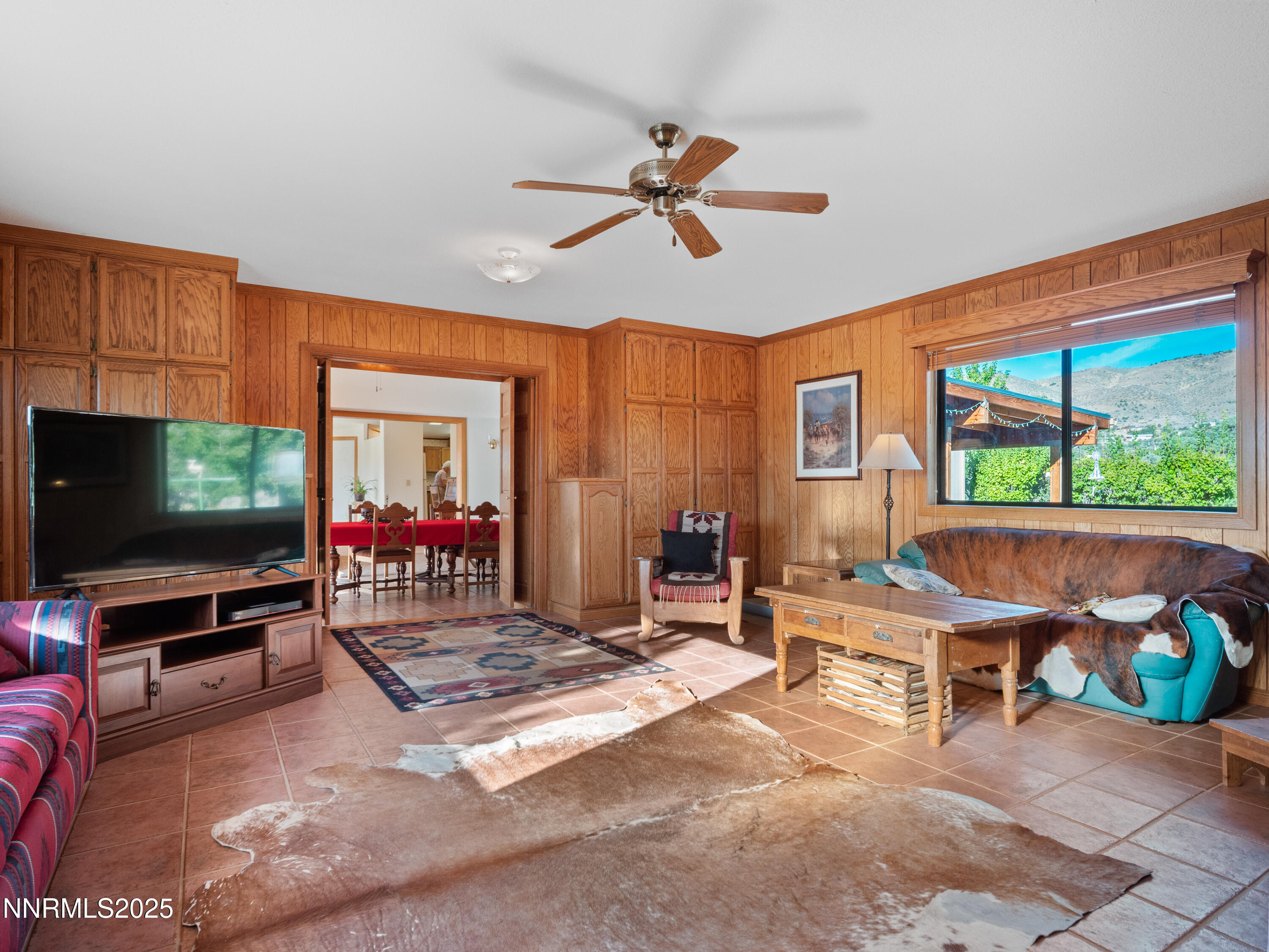 3670 Pine Nut Way Topaz Ranch Estates, NV 89444 - Photo 14 of 74 a living room with furniture a flat screen tv and a floor to ceiling window