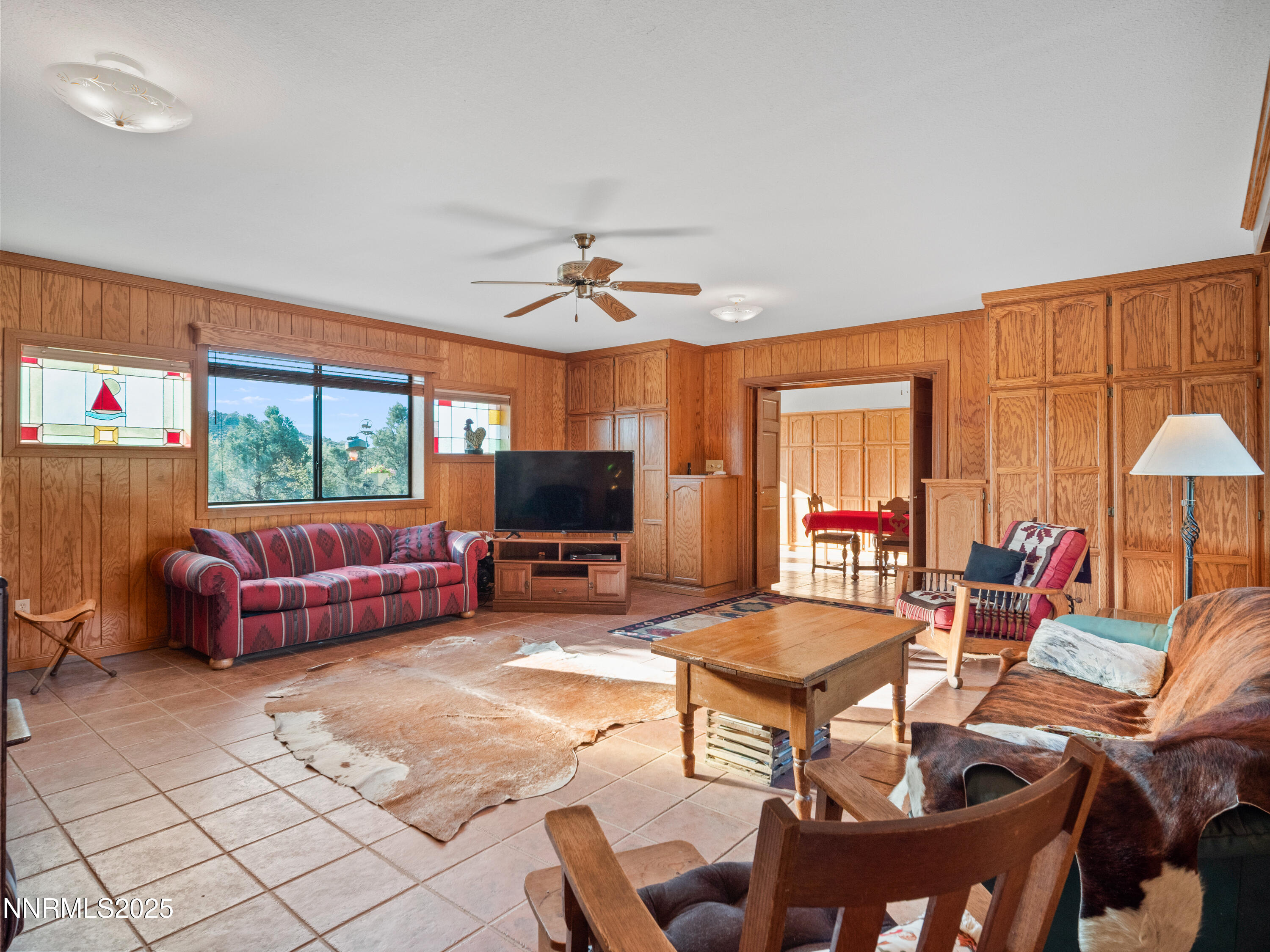 3670 Pine Nut Way Topaz Ranch Estates, NV 89444 - Photo 15 of 74 a living room with furniture a flat screen tv and a large window