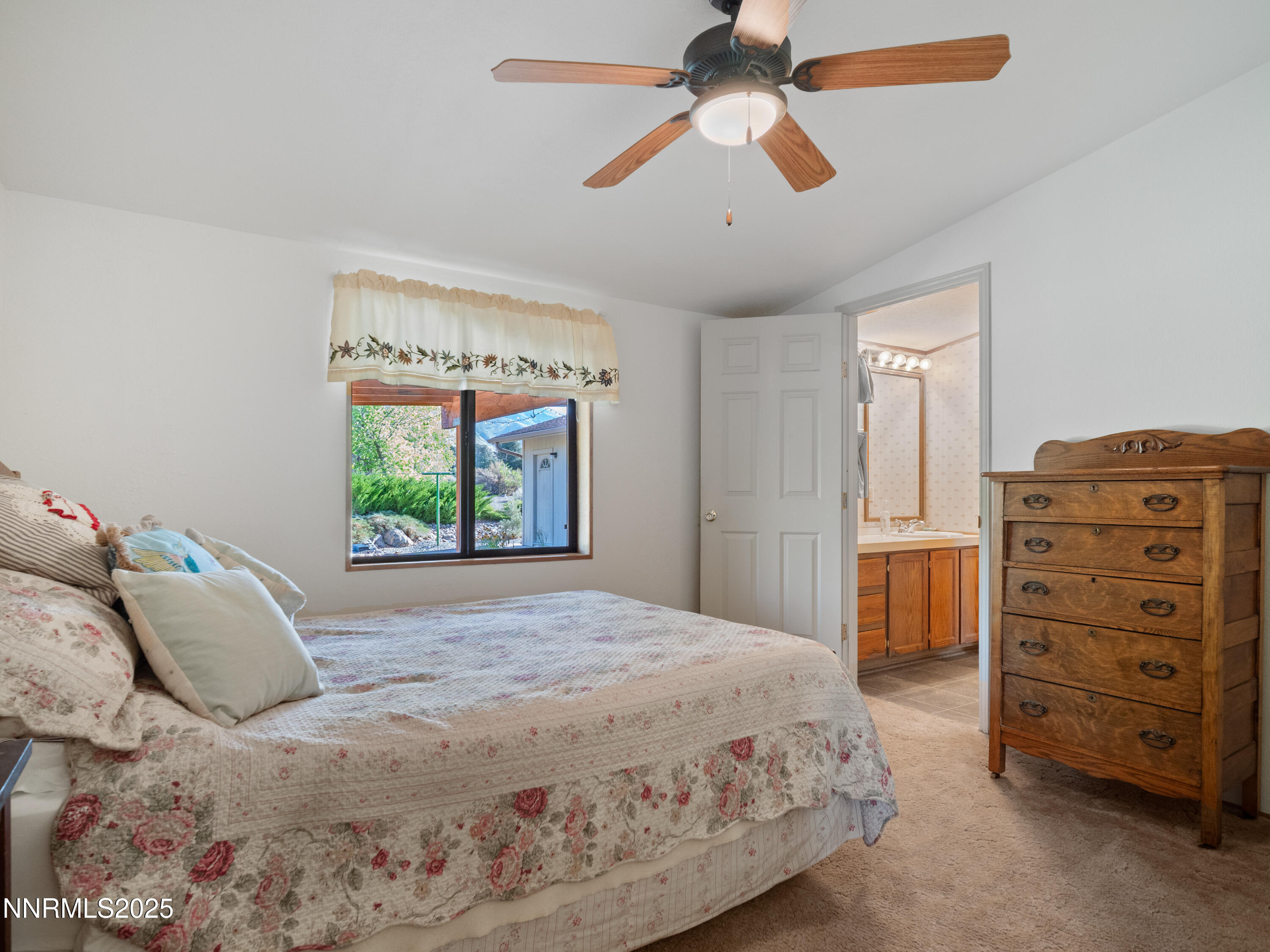 3670 Pine Nut Way Topaz Ranch Estates, NV 89444 - Photo 23 of 74 a bedroom with a bed a dresser and a chandelier