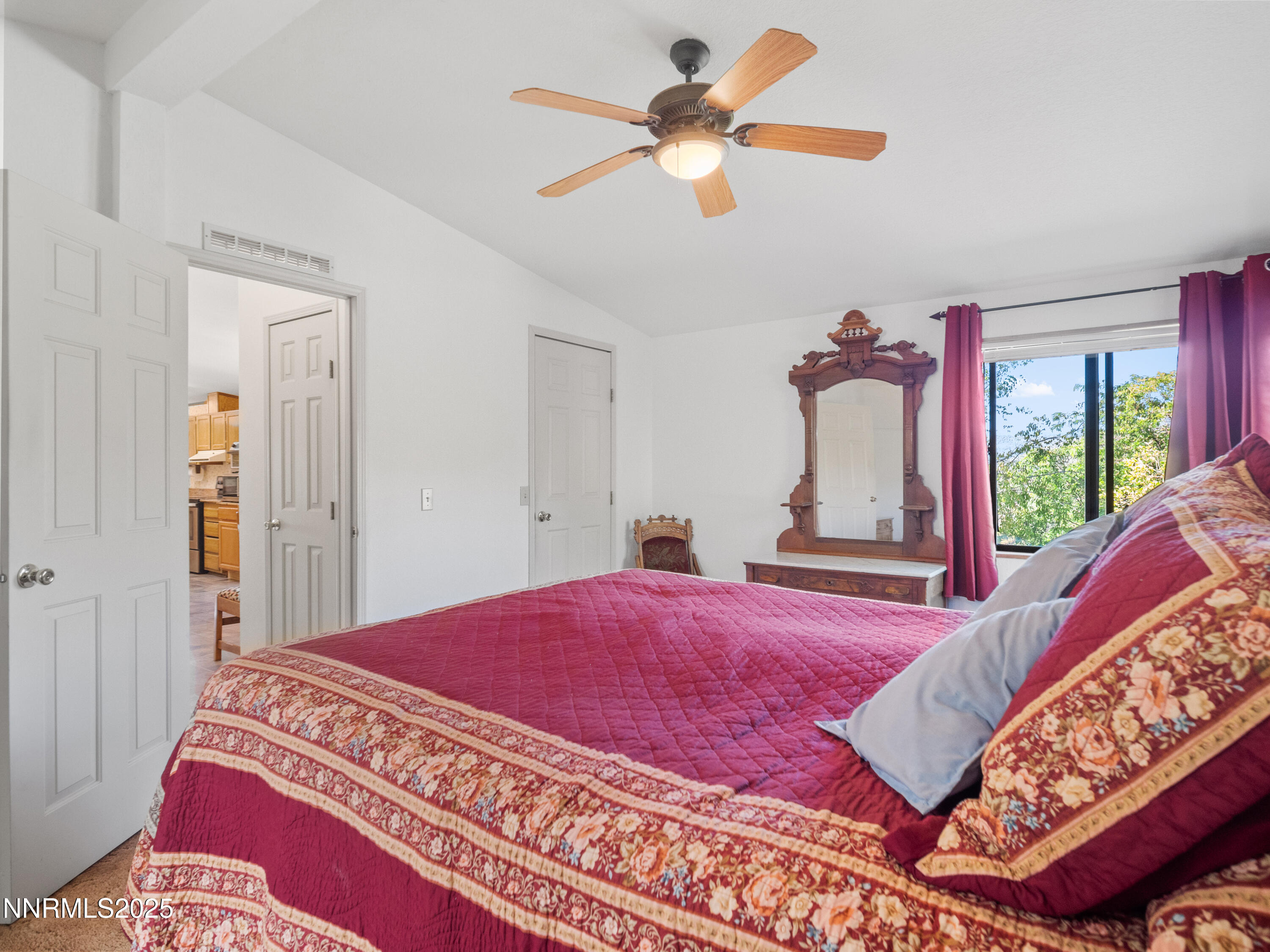 3670 Pine Nut Way Topaz Ranch Estates, NV 89444 - Photo 26 of 74 a bedroom with a large bed and a chandelier
