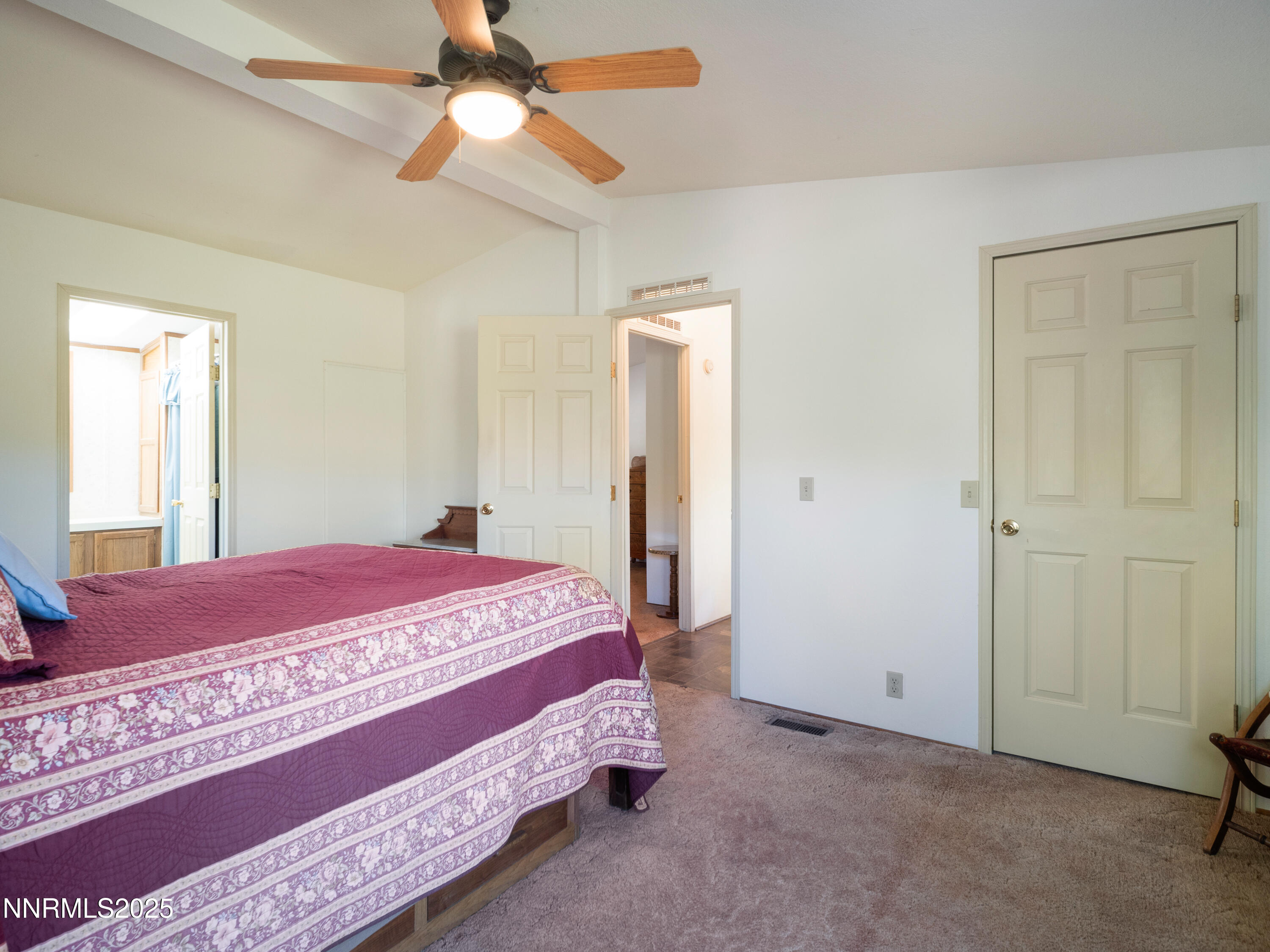 3670 Pine Nut Way Topaz Ranch Estates, NV 89444 - Photo 27 of 74 a bedroom with a bed and a chandelier