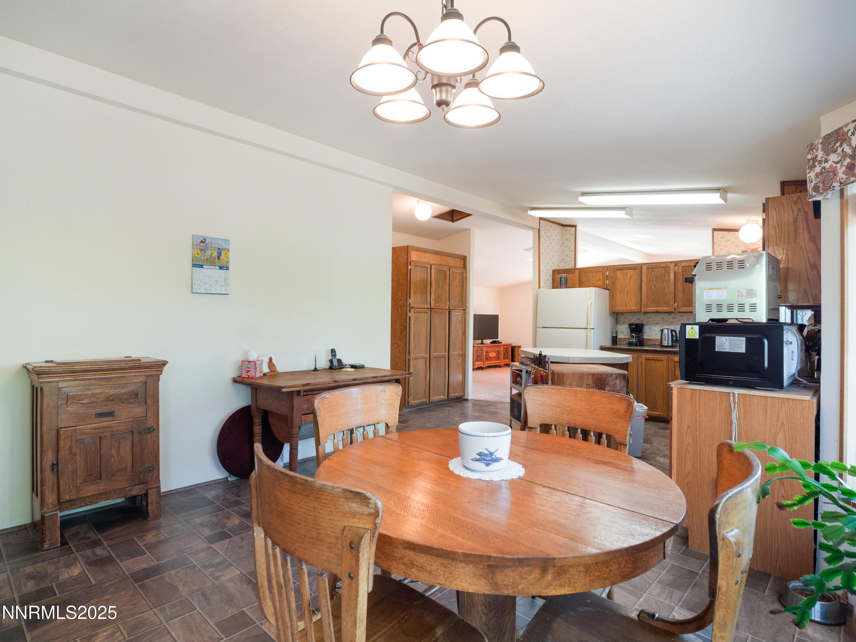 3670 Pine Nut Way Topaz Ranch Estates, NV 89444 - Photo 31 of 74 a dining room with wooden floor a chandelier a wooden table and chairs