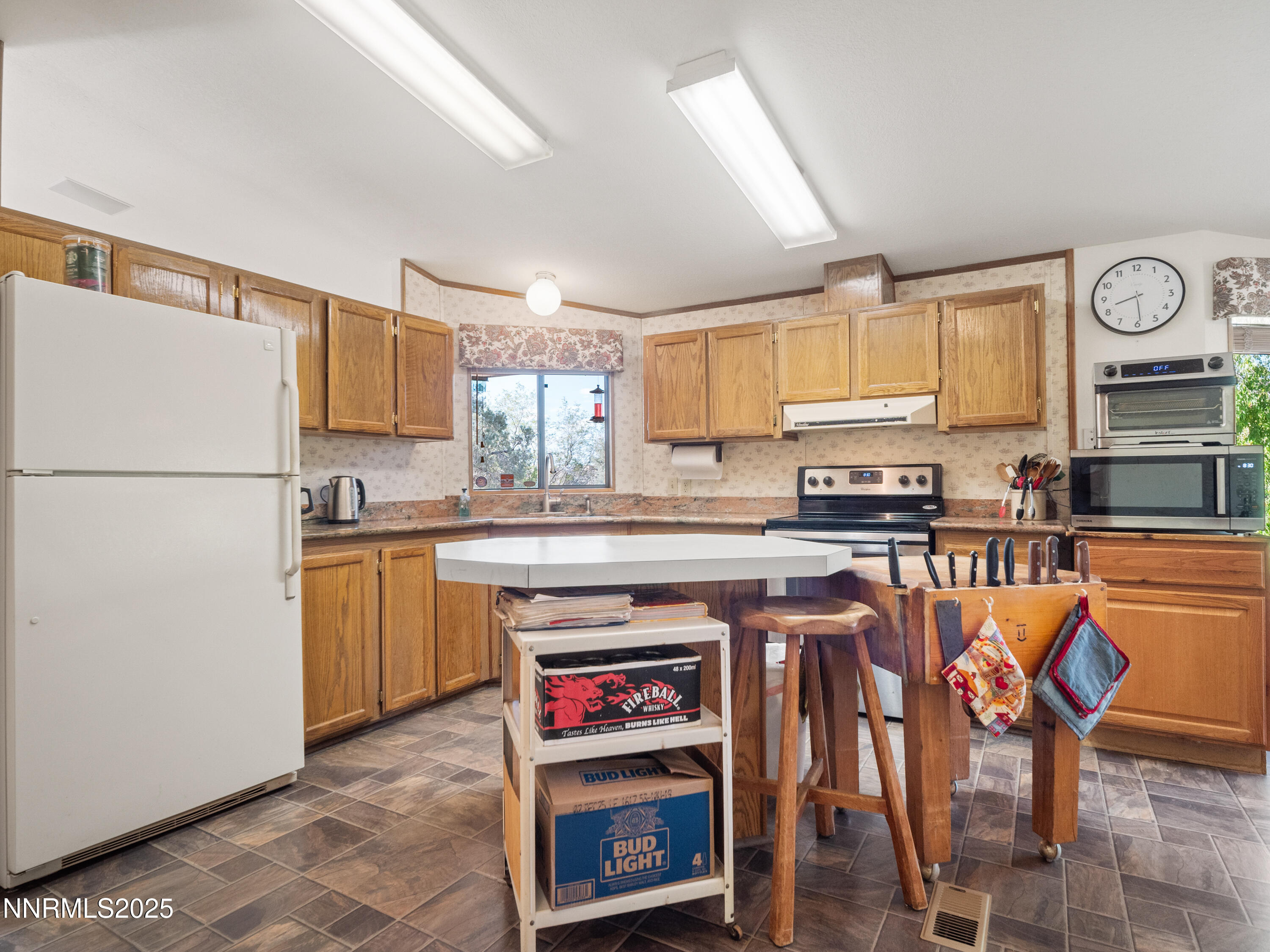 3670 Pine Nut Way Topaz Ranch Estates, NV 89444 - Photo 35 of 74 a kitchen with stainless steel appliances a stove a sink and a refrigerator