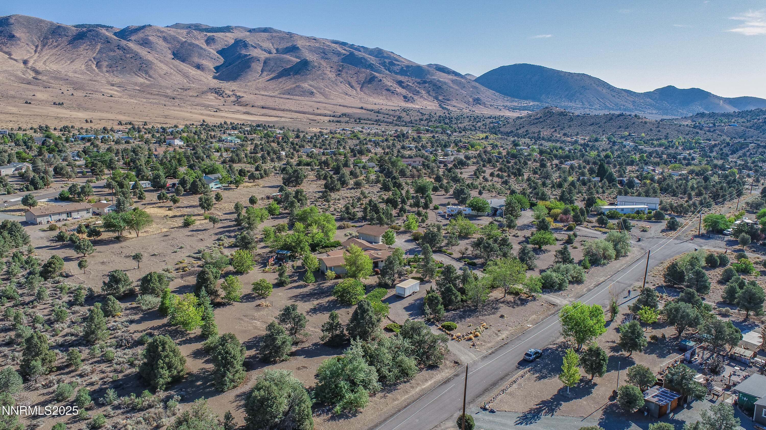 3670 Pine Nut Way Topaz Ranch Estates, NV 89444 - Photo 62 of 74 a view of a lush green hillside and a building