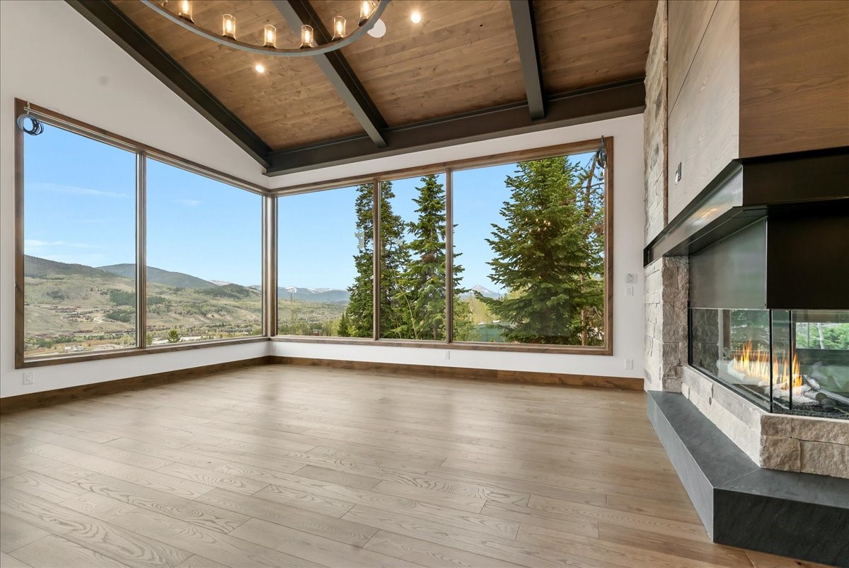 1615 Golden Eagle Road Silverthorne, CO 80498 - Photo 13 of 47 a view of an empty room with wooden floor and a window