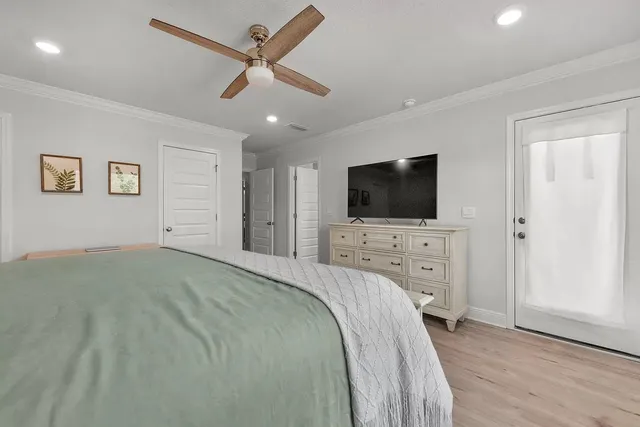 a bedroom with a bed and a ceiling fan