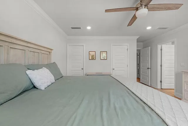 a bedroom with a bed and a ceiling fan