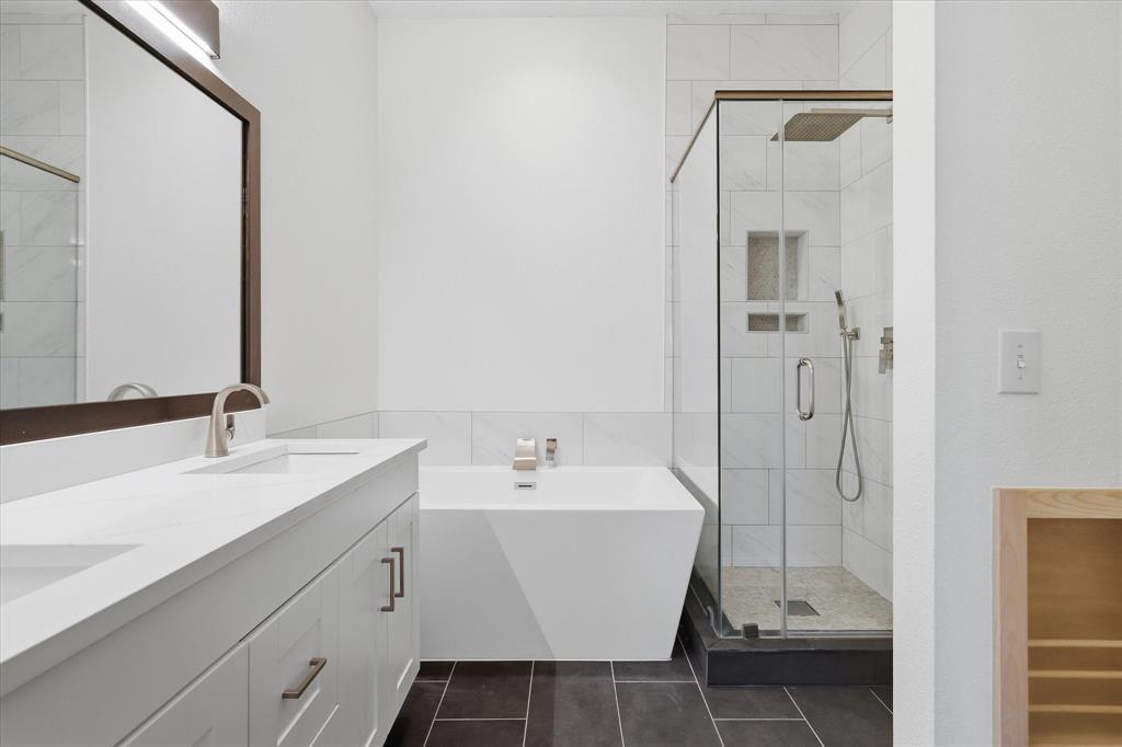 11313 Canoe Road Frisco, TX 75035 - Photo 28 of 40 The updated Primary Bath offers quartz coutnertops, a standing tub and separate shower.