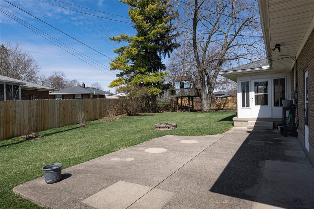 5235 West Ridgewood Road Springfield, OH 45503 - Photo 30 of 32 This expansive backyard features a spacious patio, lush lawn, and private fencing, perfect for outdoor enjoyment.
