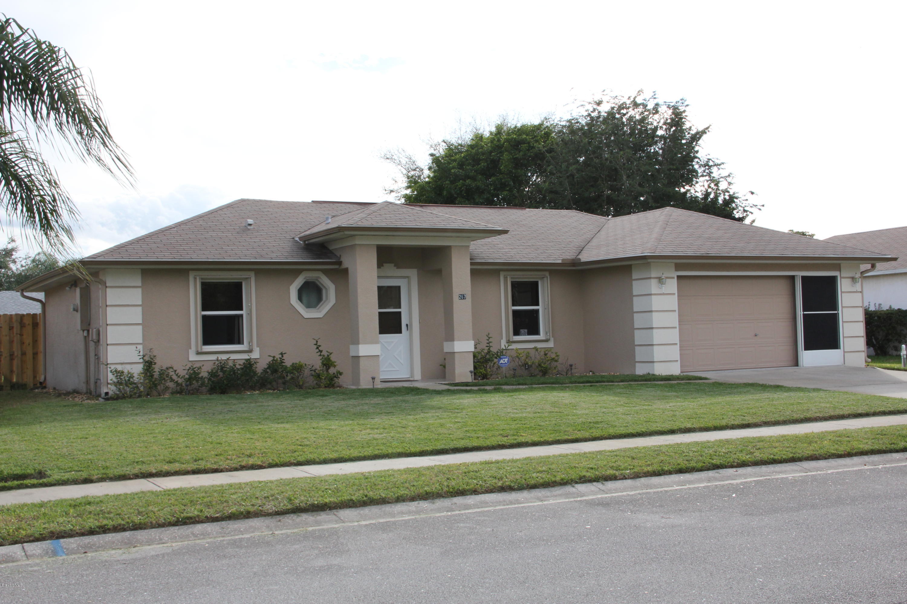 267 Twin Lakes Road Melbourne, FL 32901 - Photo 1 of 33 a front view of a house with a garden