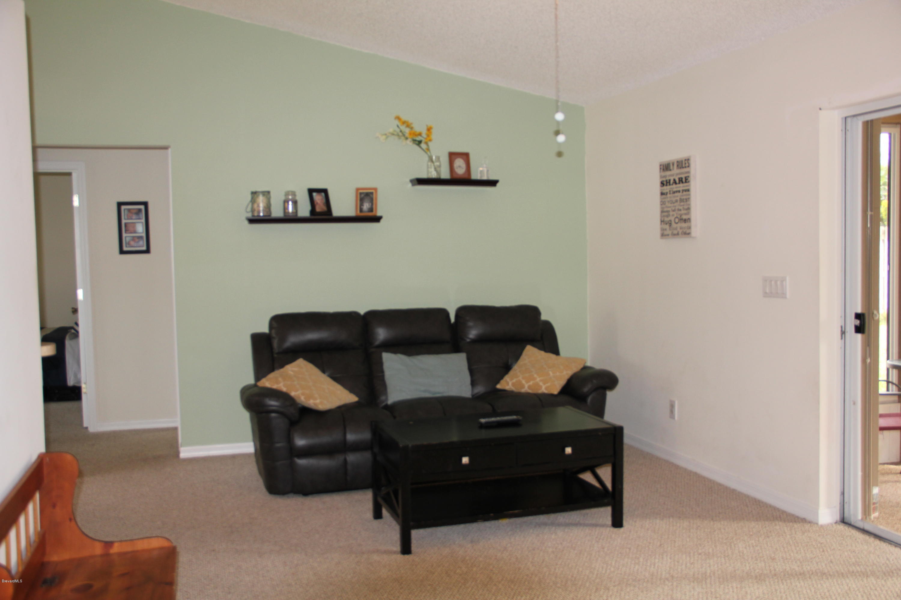267 Twin Lakes Road Melbourne, FL 32901 - Photo 11 of 33 a living room with furniture and a wooden floor