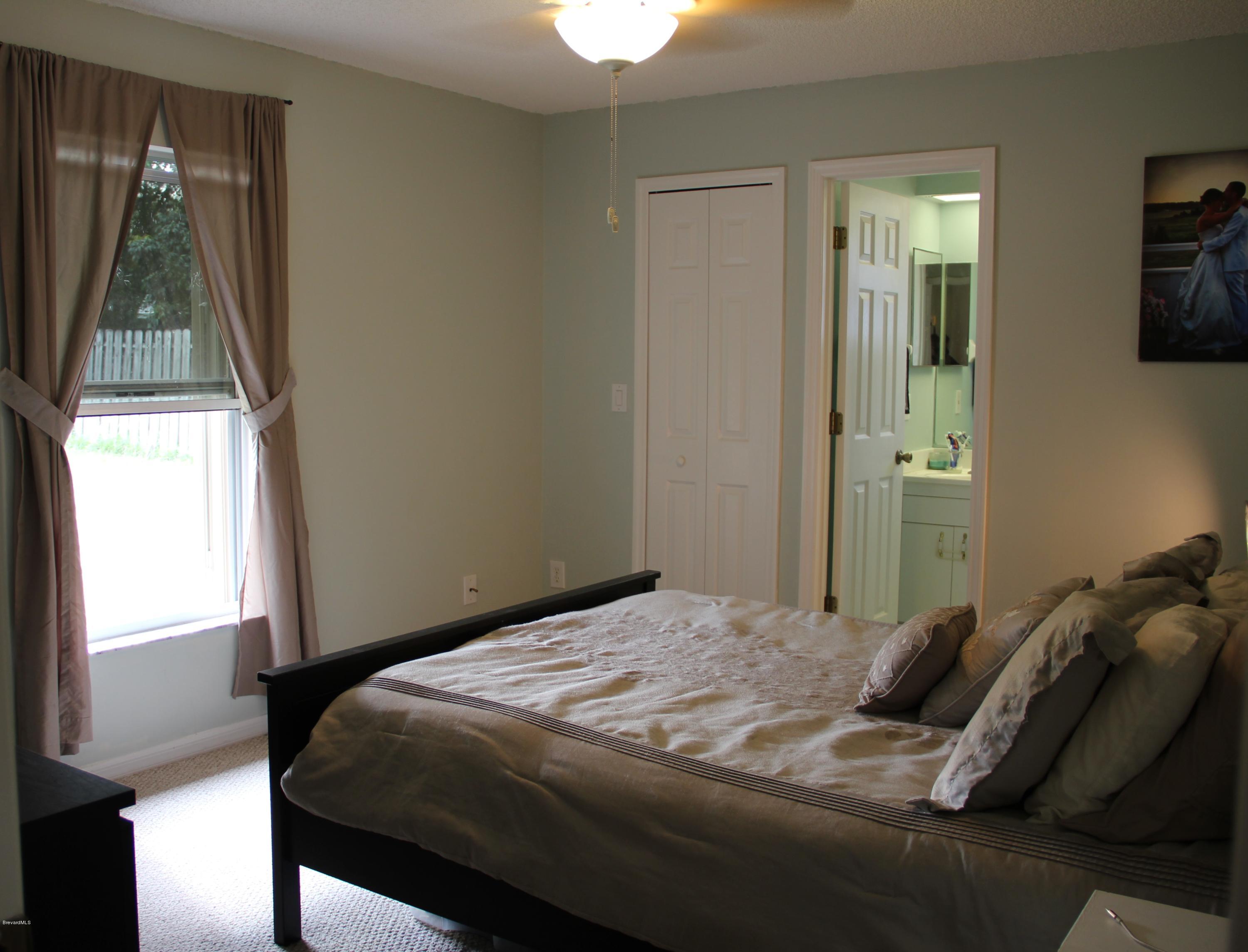267 Twin Lakes Road Melbourne, FL 32901 - Photo 3 of 33 a bedroom with a bed and a window