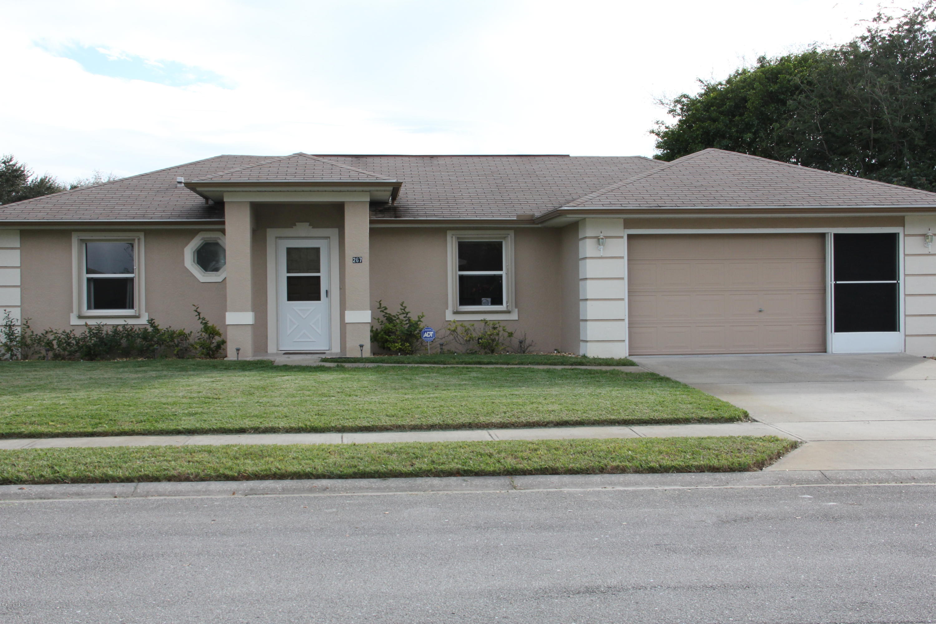 267 Twin Lakes Road Melbourne, FL 32901 - Photo 26 of 33 a front view of a house with a garden