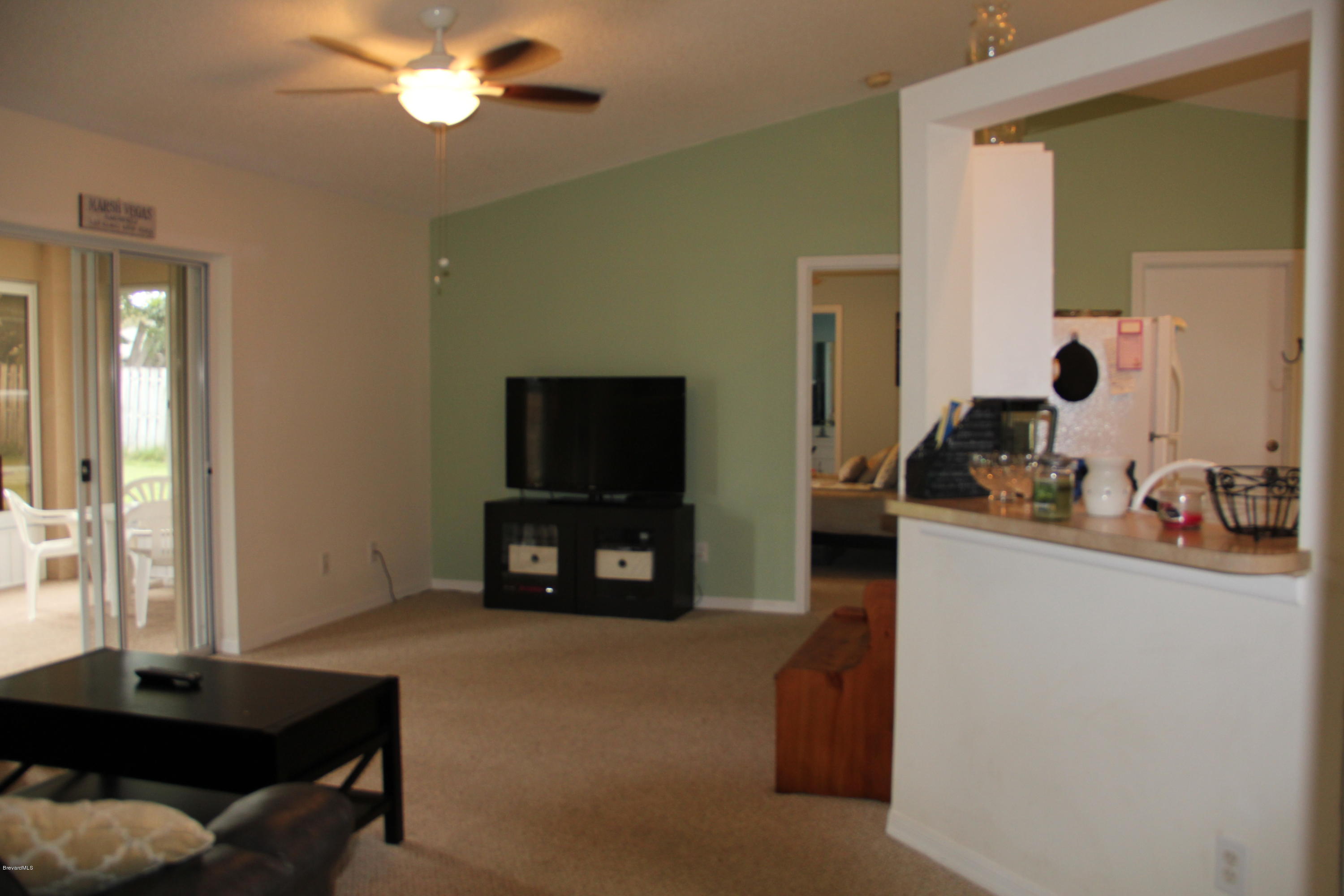 267 Twin Lakes Road Melbourne, FL 32901 - Photo 10 of 33 a living room with furniture and a flat screen tv