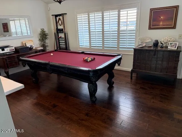 a room with pool table and windows