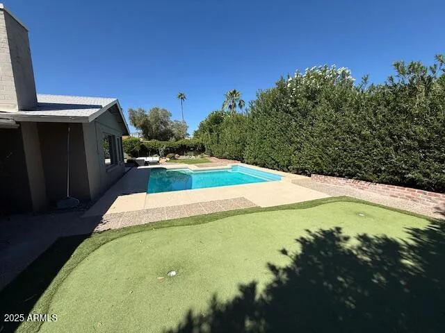 a view of a house with backyard and porch