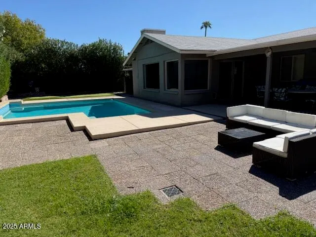 a view of a couches in the patio with a small yard