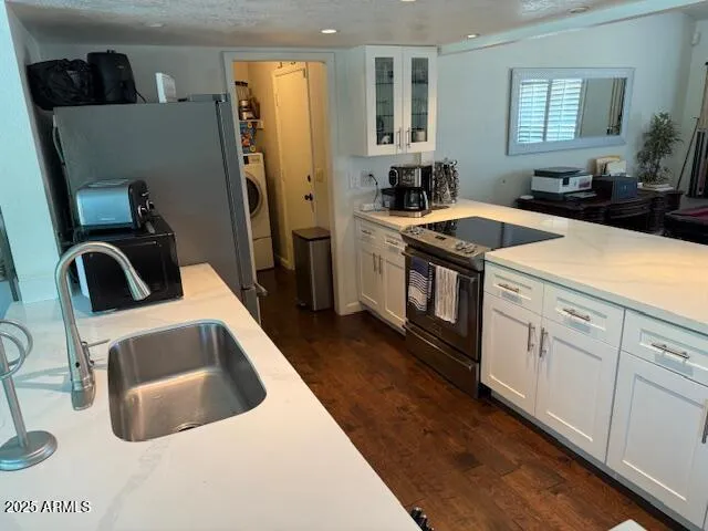 a kitchen with a sink and a stove top oven