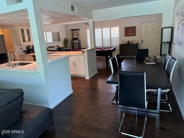 a dining room with furniture and wooden floor