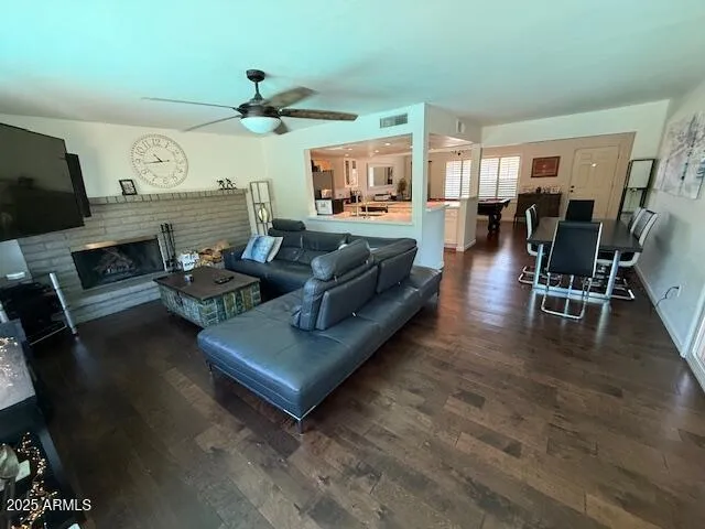 a living room with fireplace furniture and a wooden floor