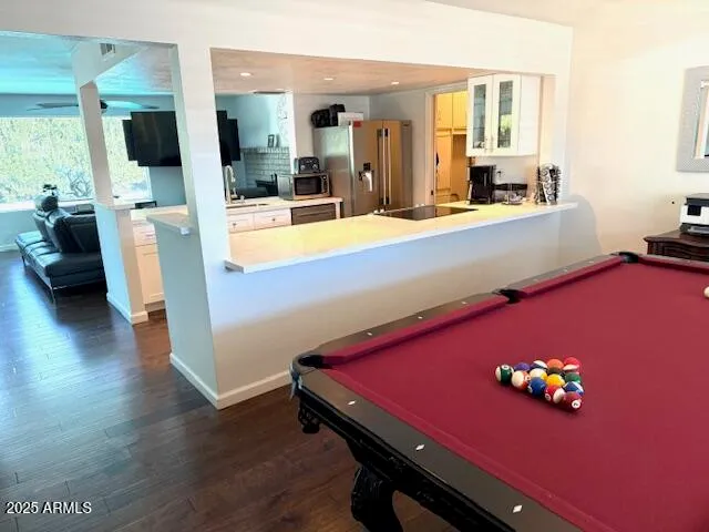 a room with pool table and flat screen tv
