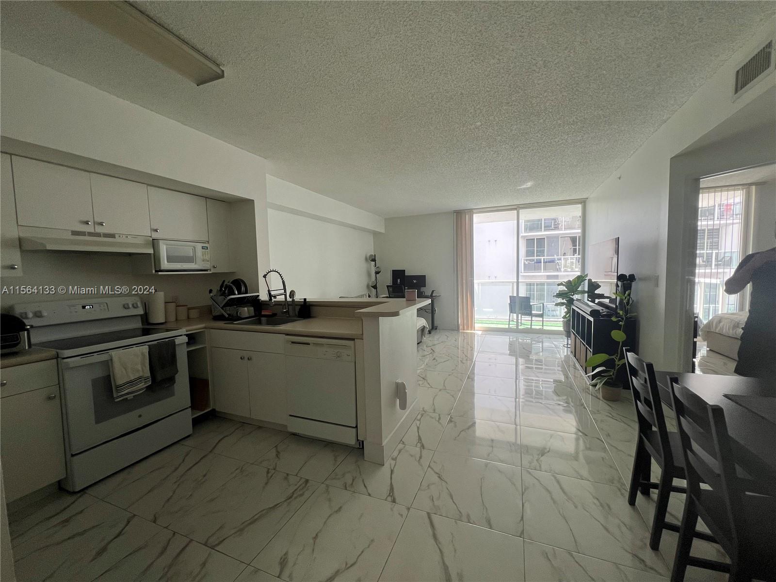 Flagami Miami, FL 33126 - Photo 1 of 16 a kitchen with a sink white cabinets and appliances
