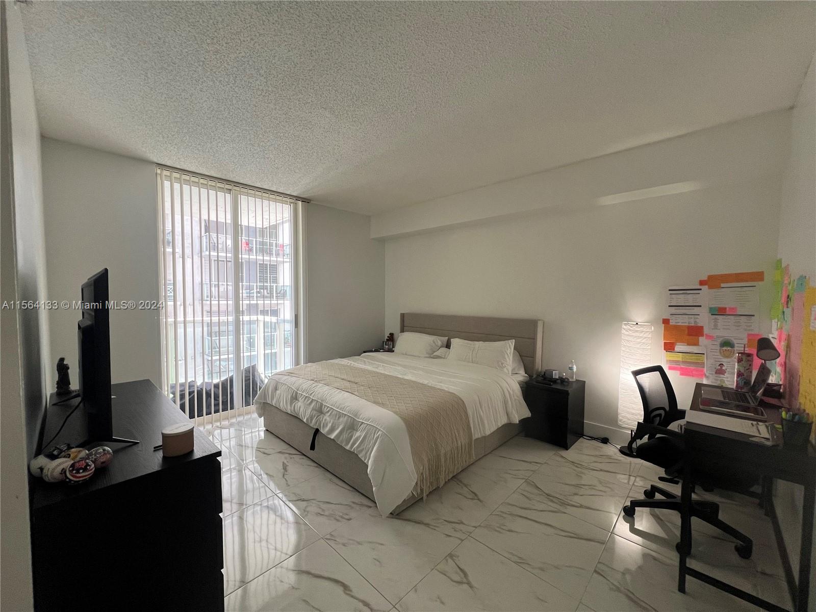 Flagami Miami, FL 33126 - Photo 3 of 16 a bedroom with a bed and a flat tv screen on a dresser