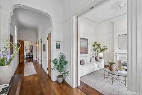 a living room with furniture and a potted plant