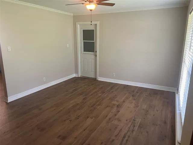 an empty room with a chandelier fan