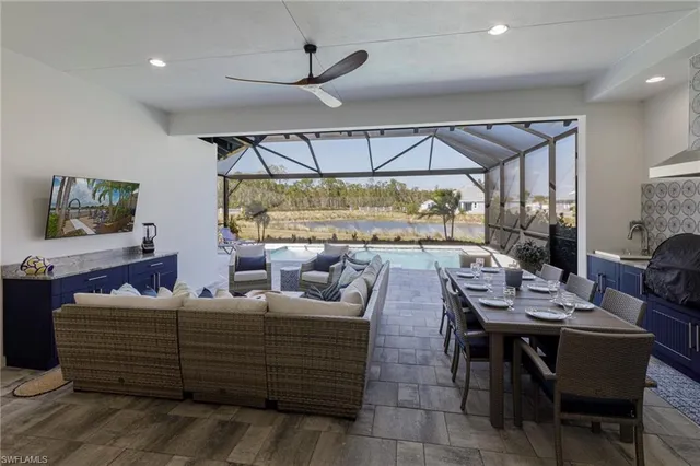 a view of a backyard with table and chairs under an umbrella