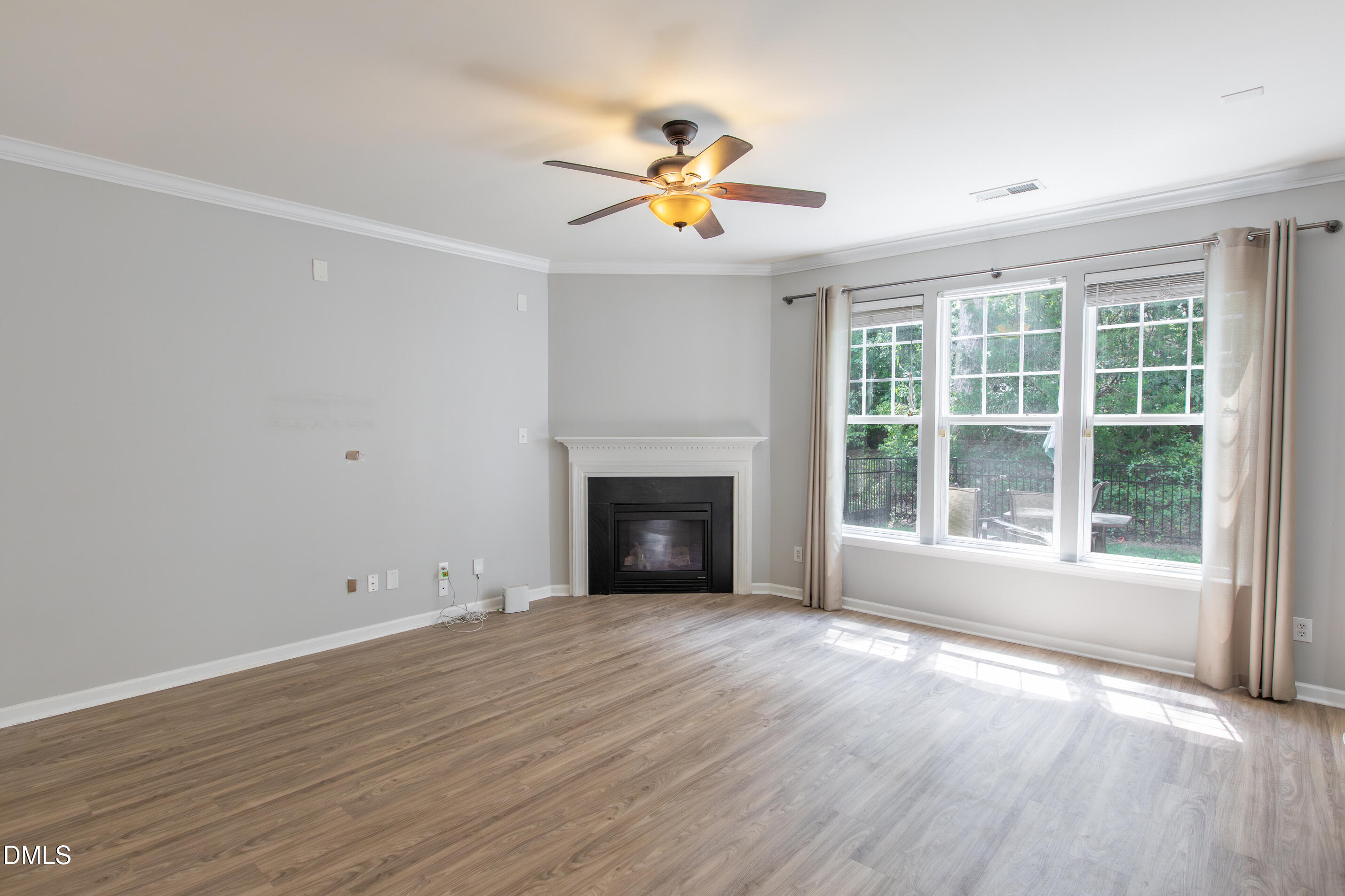 8006 Morrell Lane Durham, NC 27713 - Photo 13 of 38 a view of empty room with wooden floor and fan