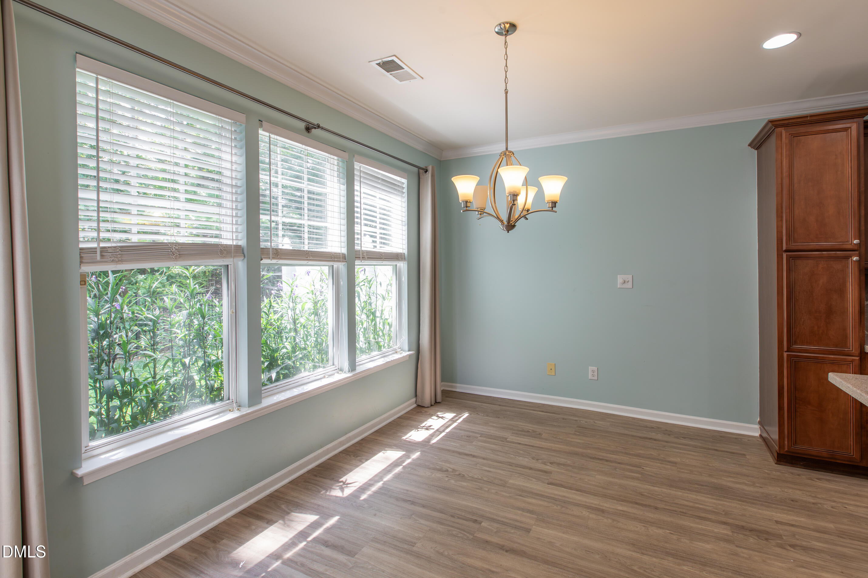 8006 Morrell Lane Durham, NC 27713 - Photo 15 of 38 a view of an empty room with wooden floor and a window