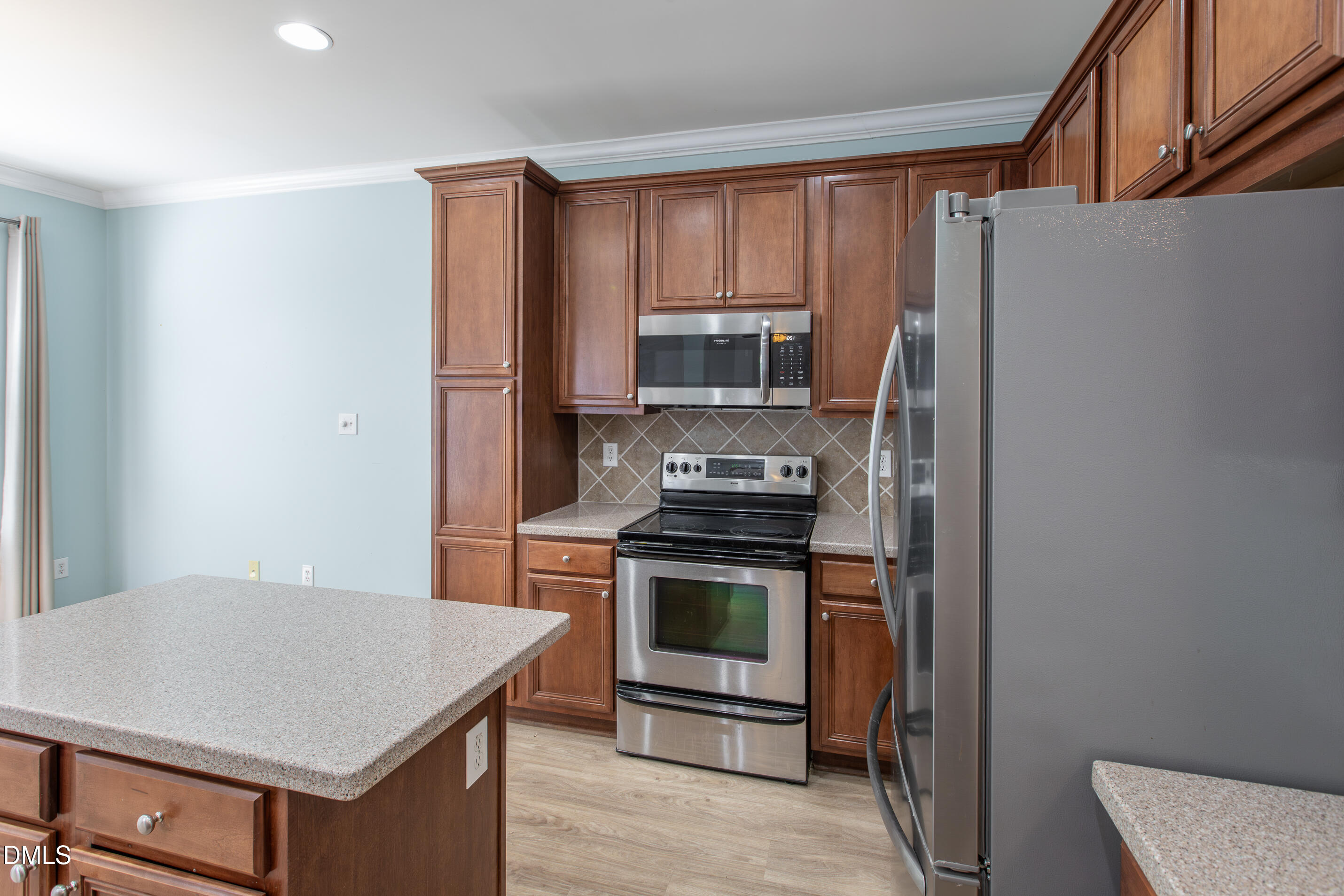8006 Morrell Lane Durham, NC 27713 - Photo 18 of 38 a kitchen with a stove a sink and a refrigerator