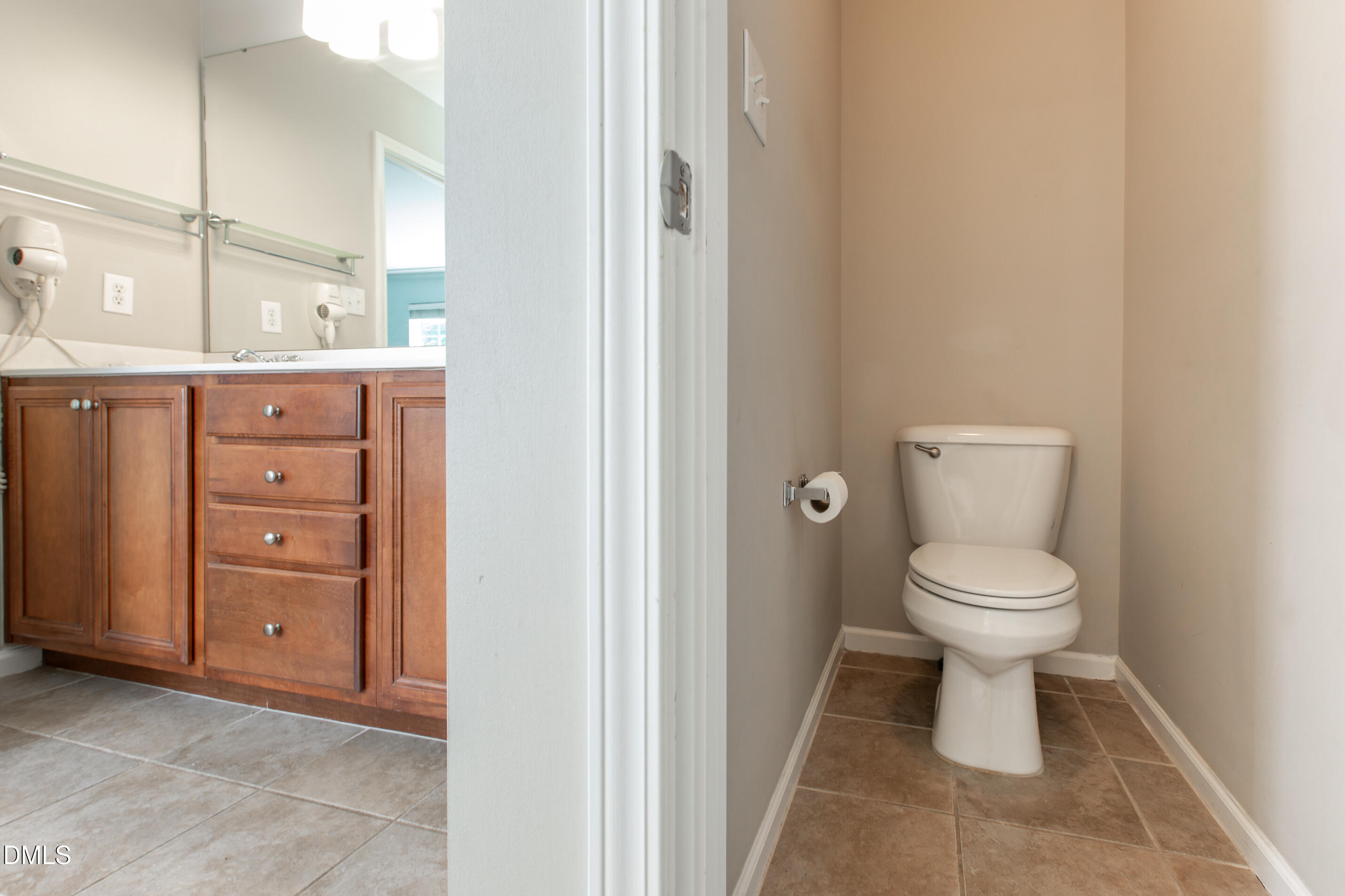 8006 Morrell Lane Durham, NC 27713 - Photo 27 of 38 a bathroom with a toilet a sink and a mirror