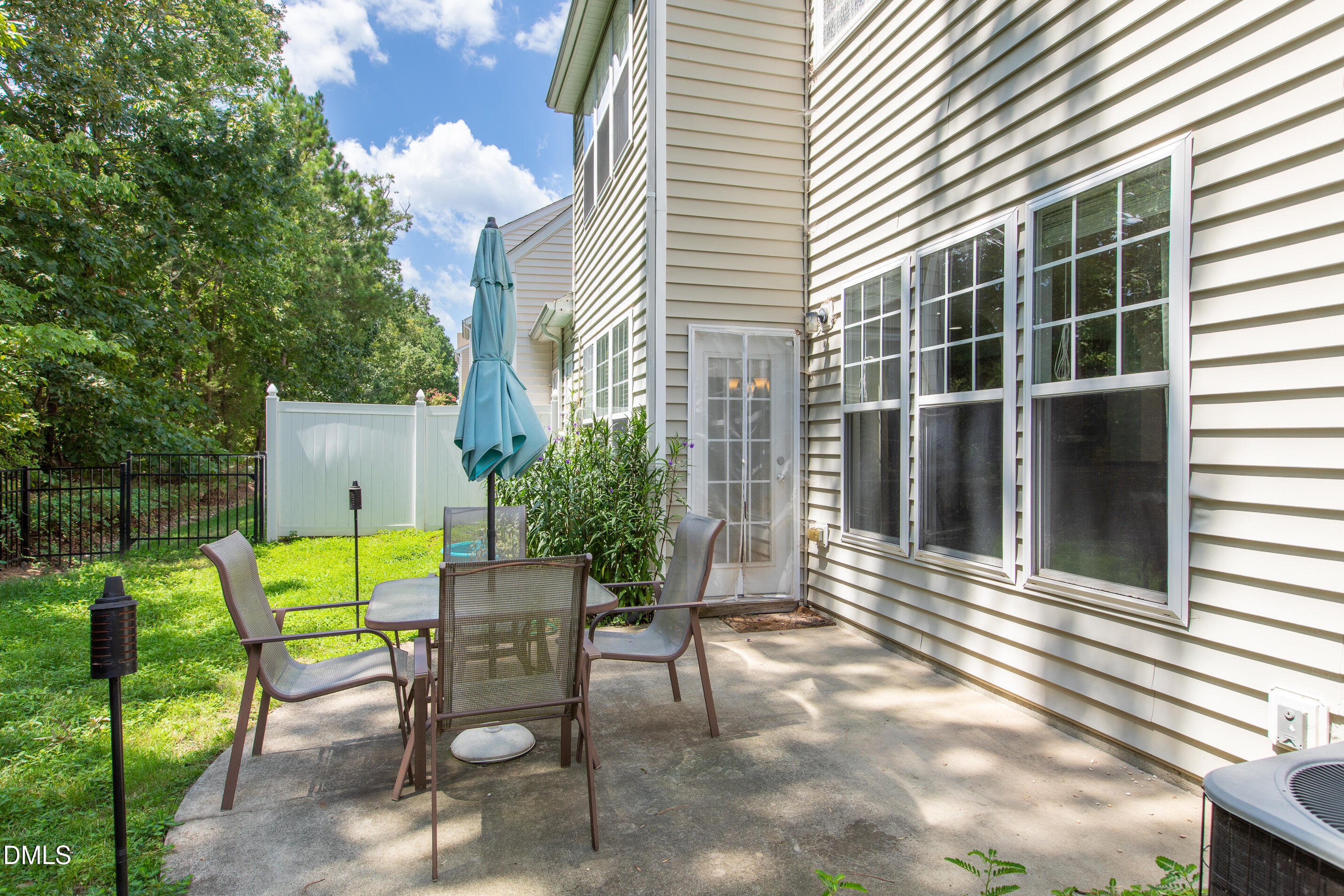 8006 Morrell Lane Durham, NC 27713 - Photo 38 of 38 a view of a patio with a table and chairs and potted plants