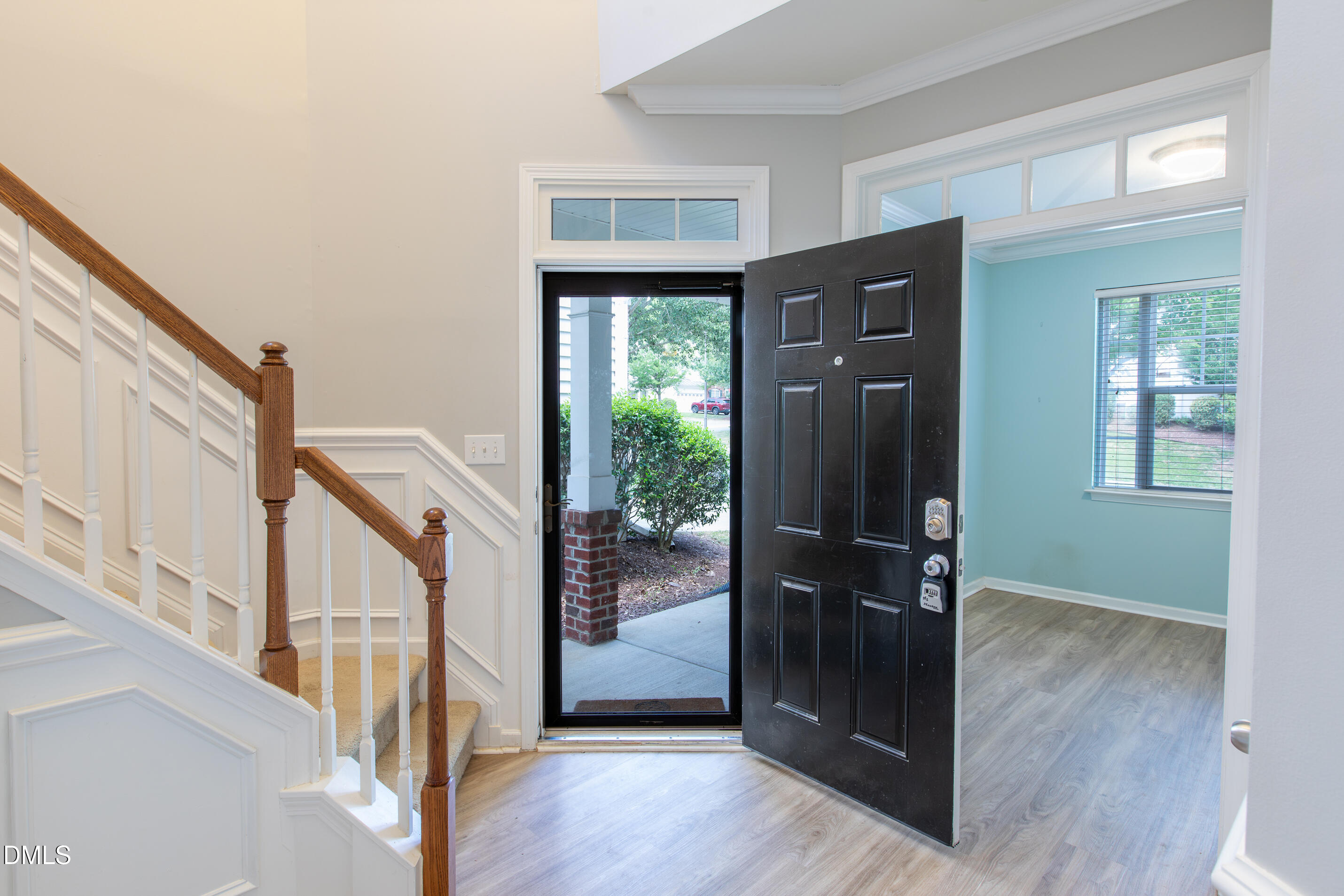 8006 Morrell Lane Durham, NC 27713 - Photo 5 of 38 a view of a hallway with wooden floor staircase and windows