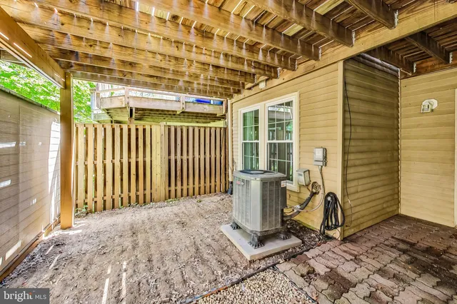 a front view of a house with a large tree
