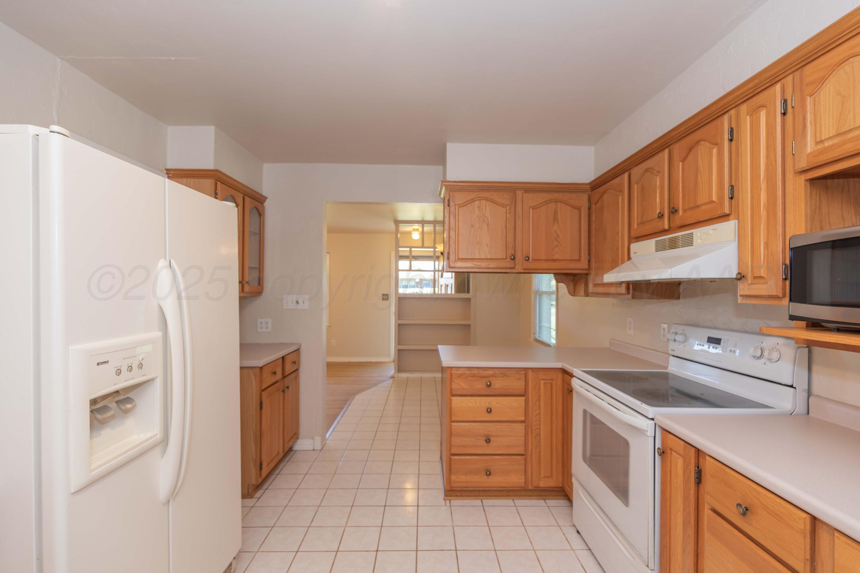 3513 Concord Road Amarillo, TX 79109 - Photo 12 of 45 a kitchen with stainless steel appliances a refrigerator sink and cabinets