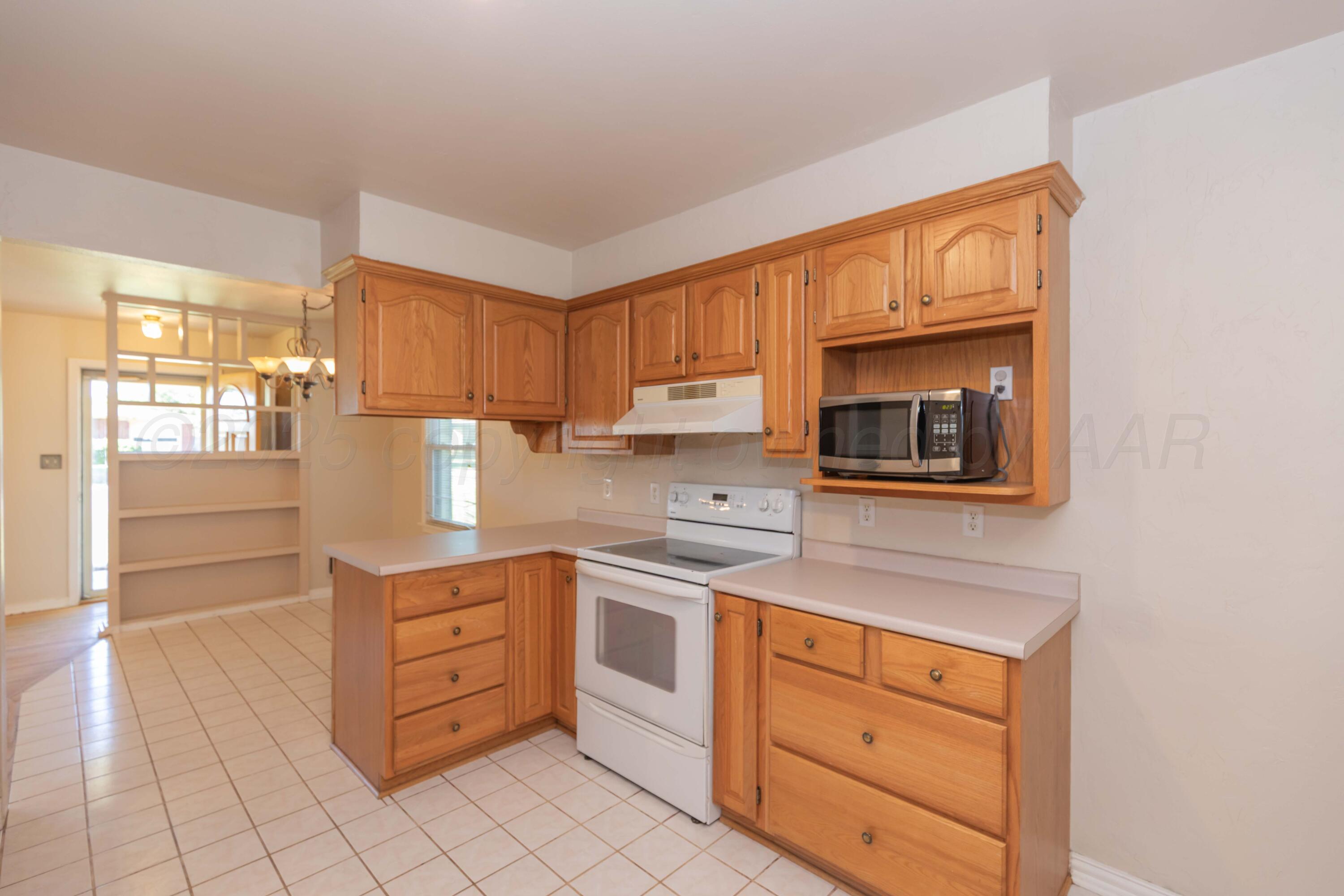 3513 Concord Road Amarillo, TX 79109 - Photo 13 of 45 a kitchen with stainless steel appliances granite countertop a stove and a sink