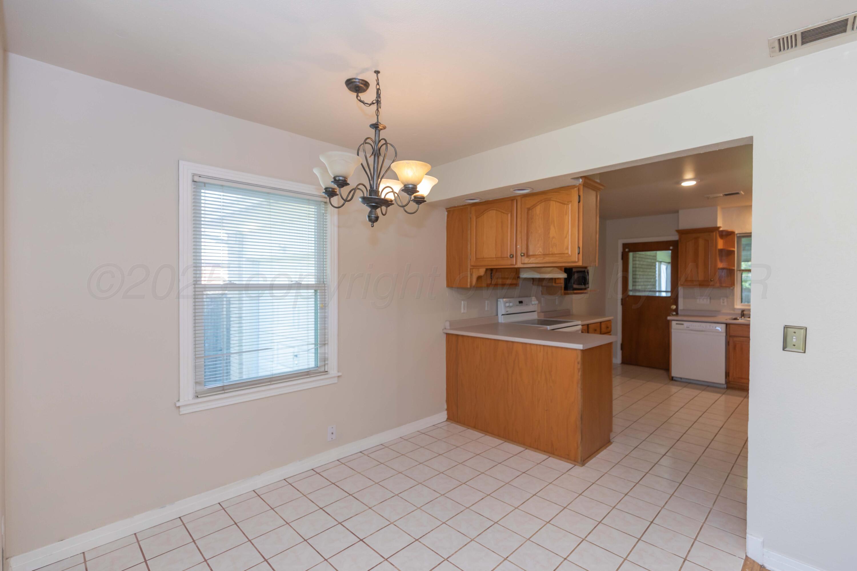 3513 Concord Road Amarillo, TX 79109 - Photo 15 of 45 a room with kitchen island stainless steel appliances furniture and window