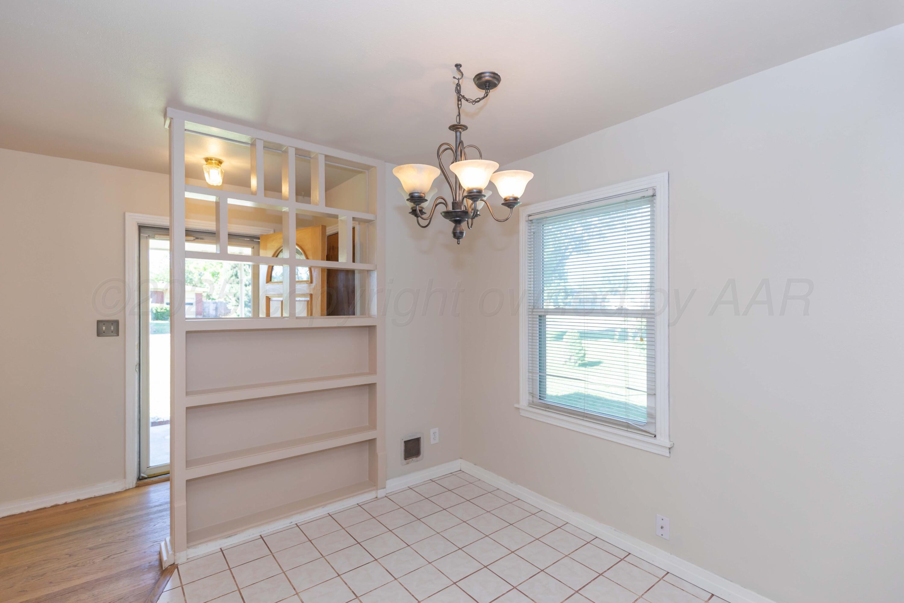 3513 Concord Road Amarillo, TX 79109 - Photo 16 of 45 a view of a room with a chandelier fan and windows